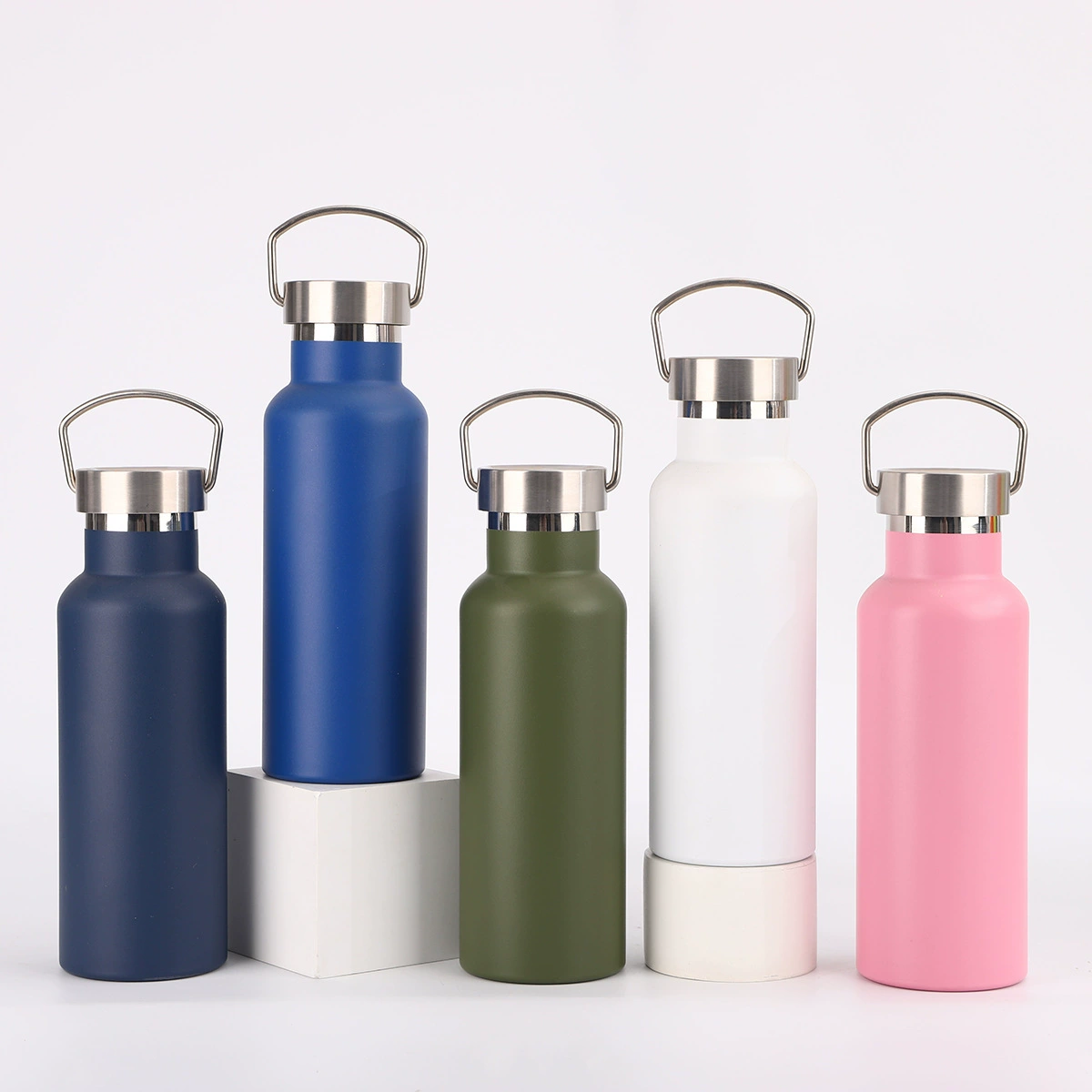 Loop handle water bottles in several colors on a light background.